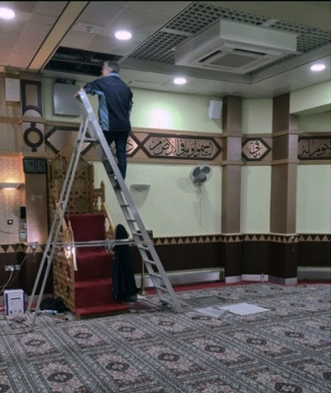Man installing professional sound solutions for mosques